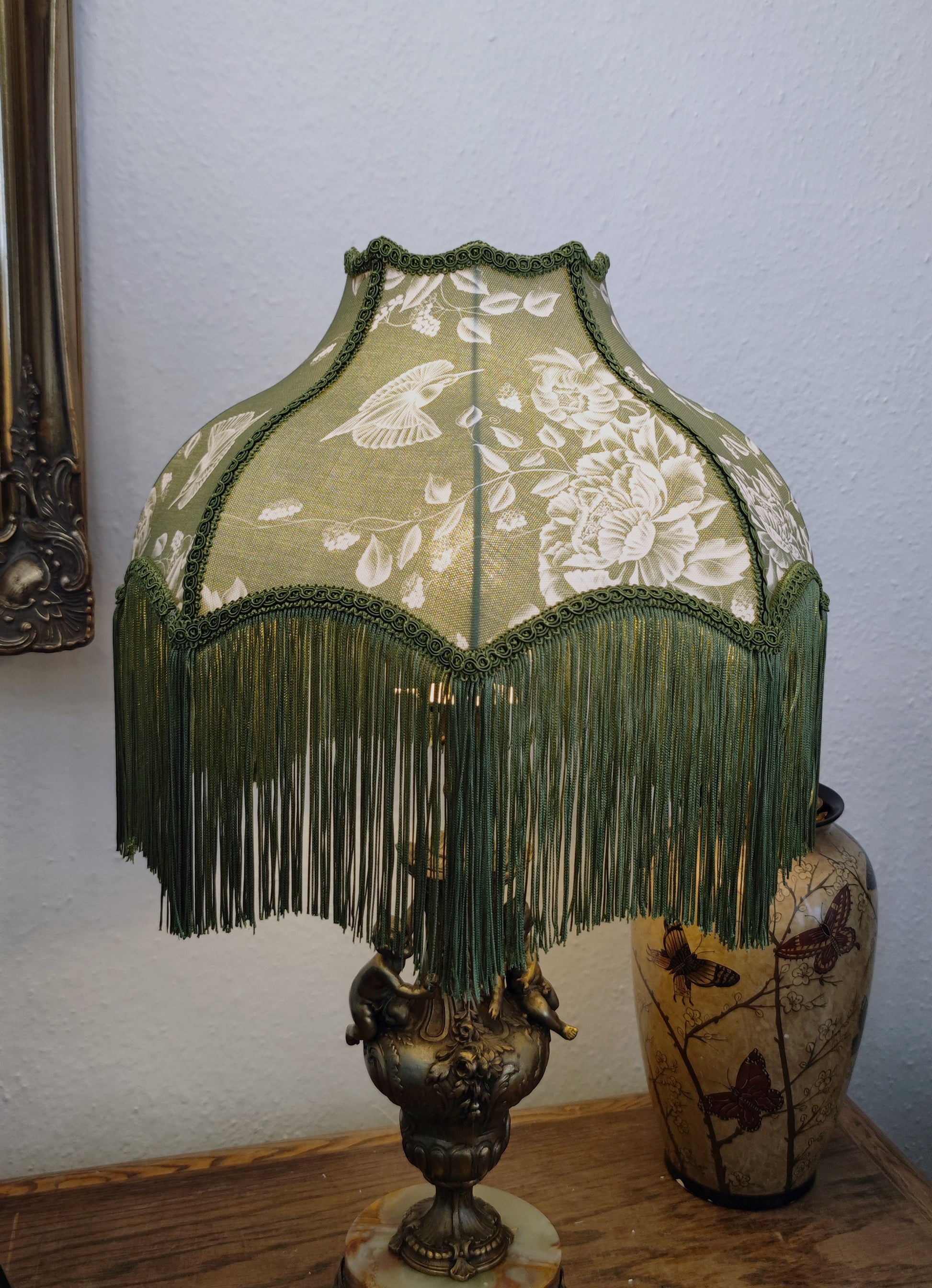 Lampshade decorated with olive green fringe and trim