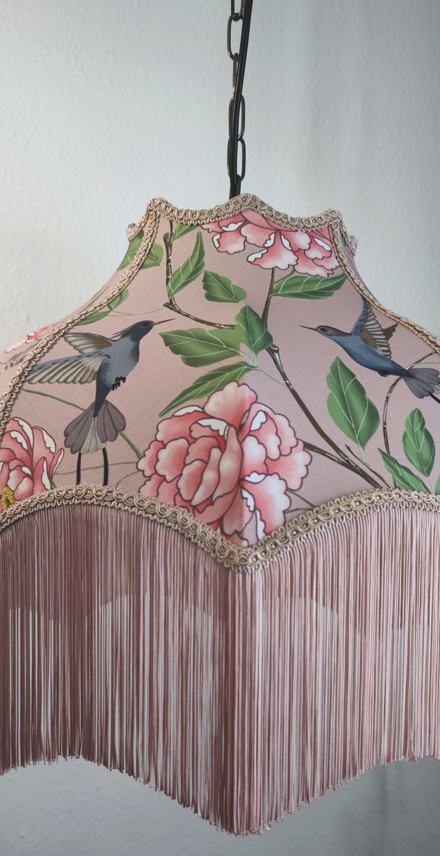 Lampshade decorated with blush complementary fringe and trim