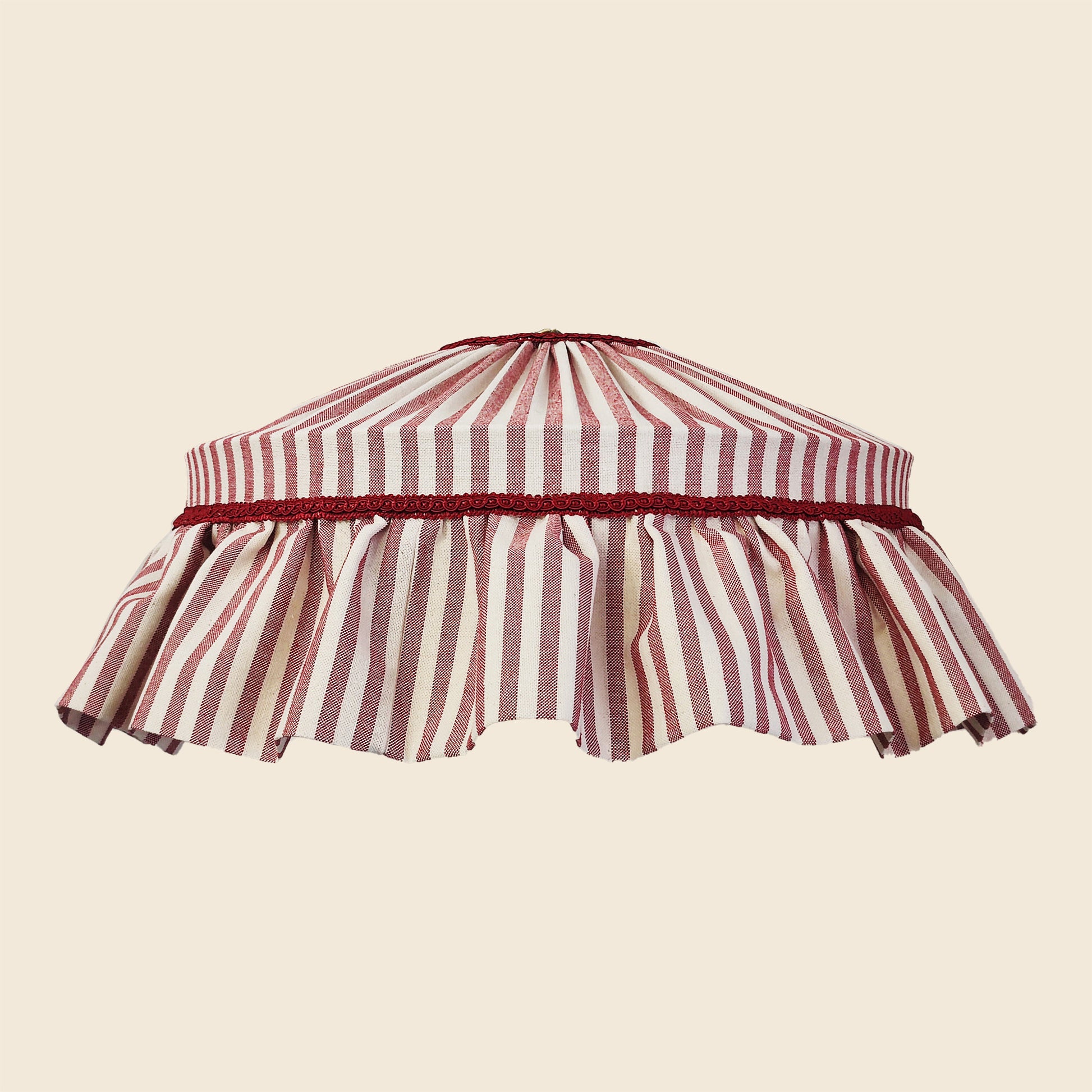 Striped lampshade with a red and white pattern on a beige background