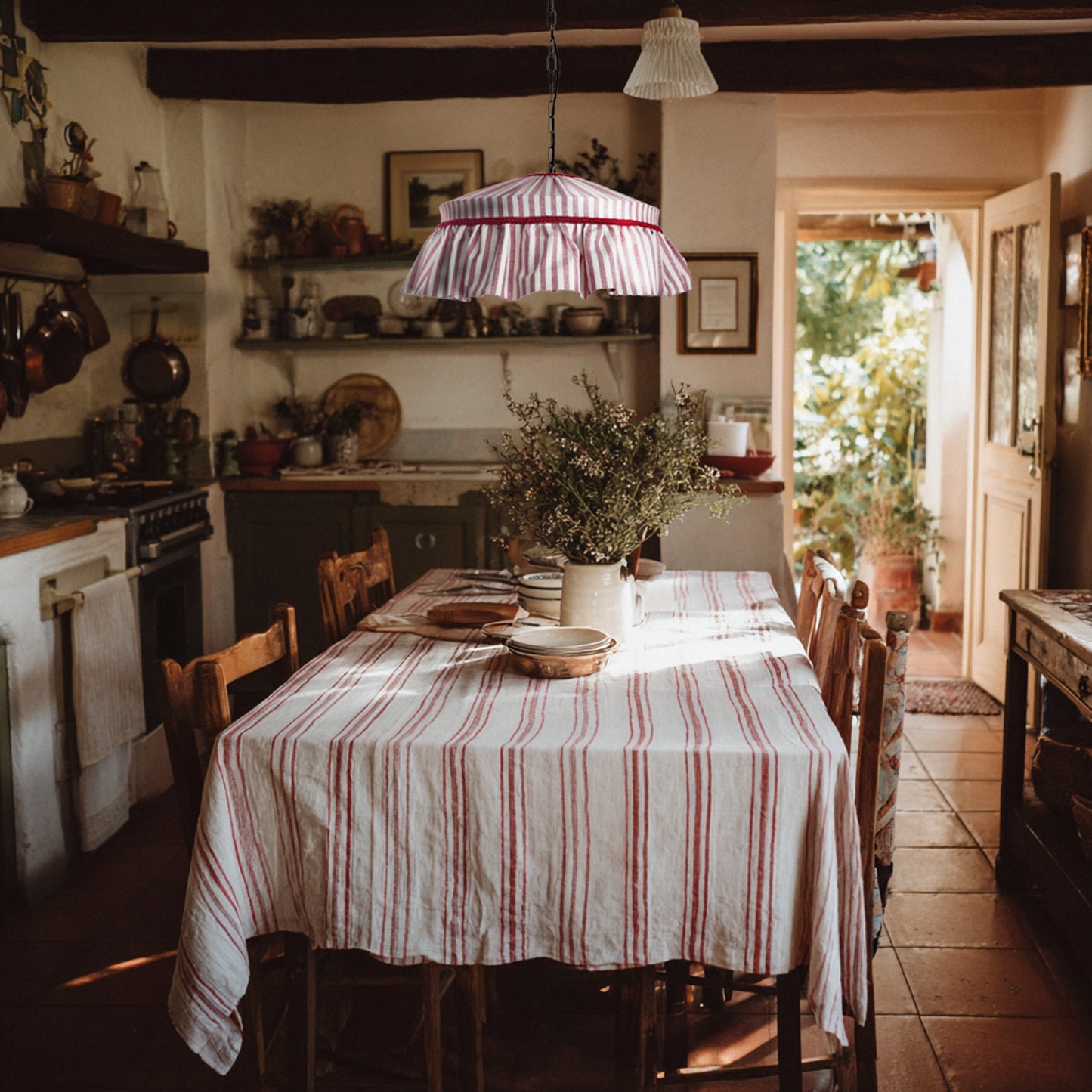Dining room with a striped tablecloth, chairs, and a hanging red striped ruffled lampshade.