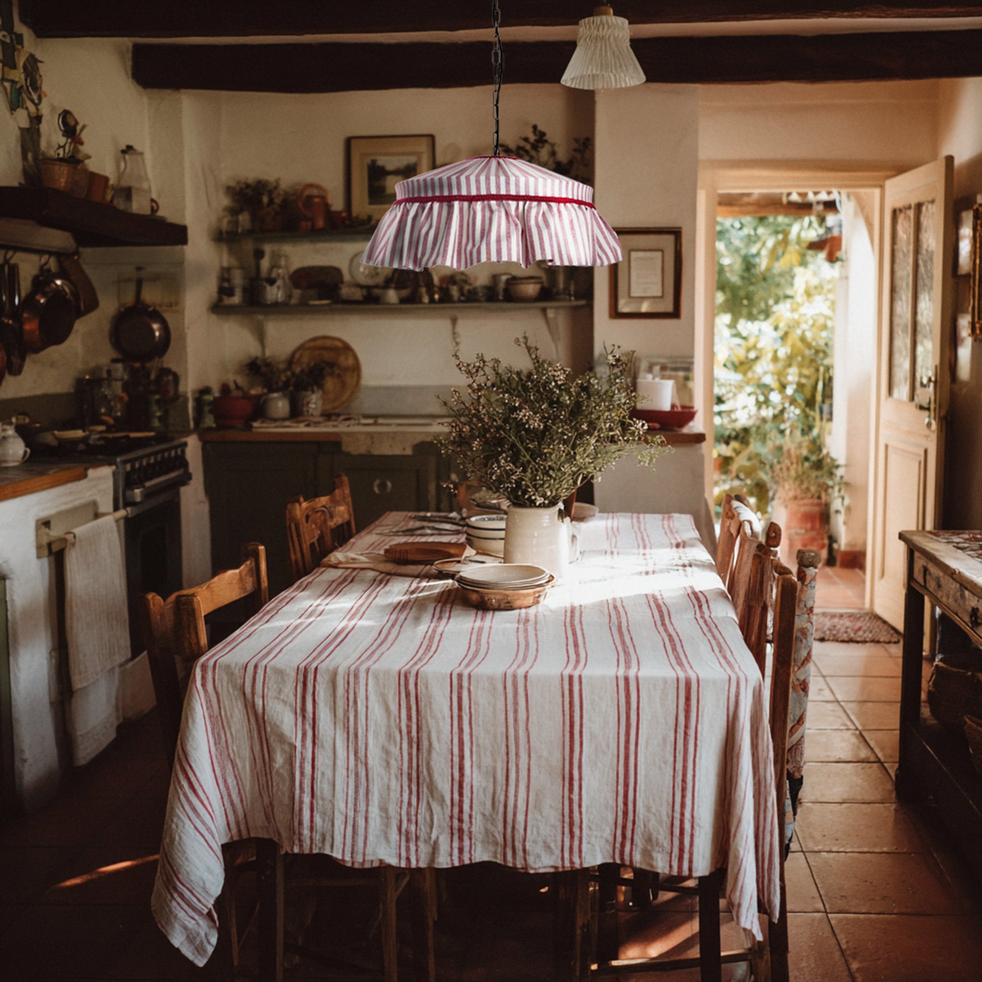 Dining room with a striped tablecloth, chairs, and a hanging red striped ruffled lampshade.