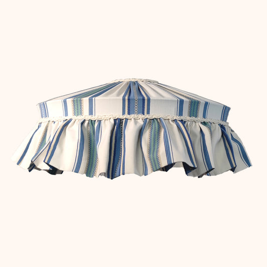 Striped lampshade with ruffled edge on a white background