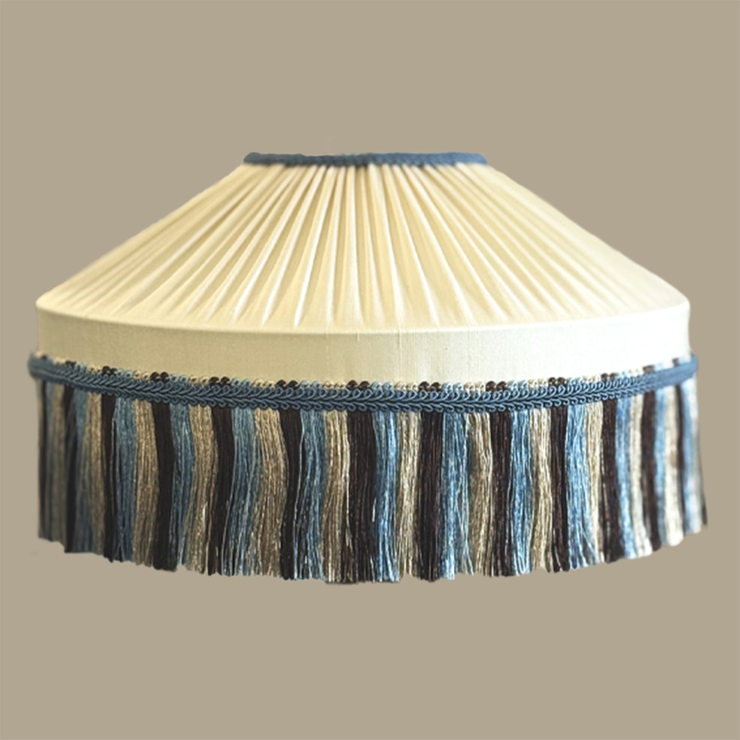 Cream pleated lampshade with blue fringe