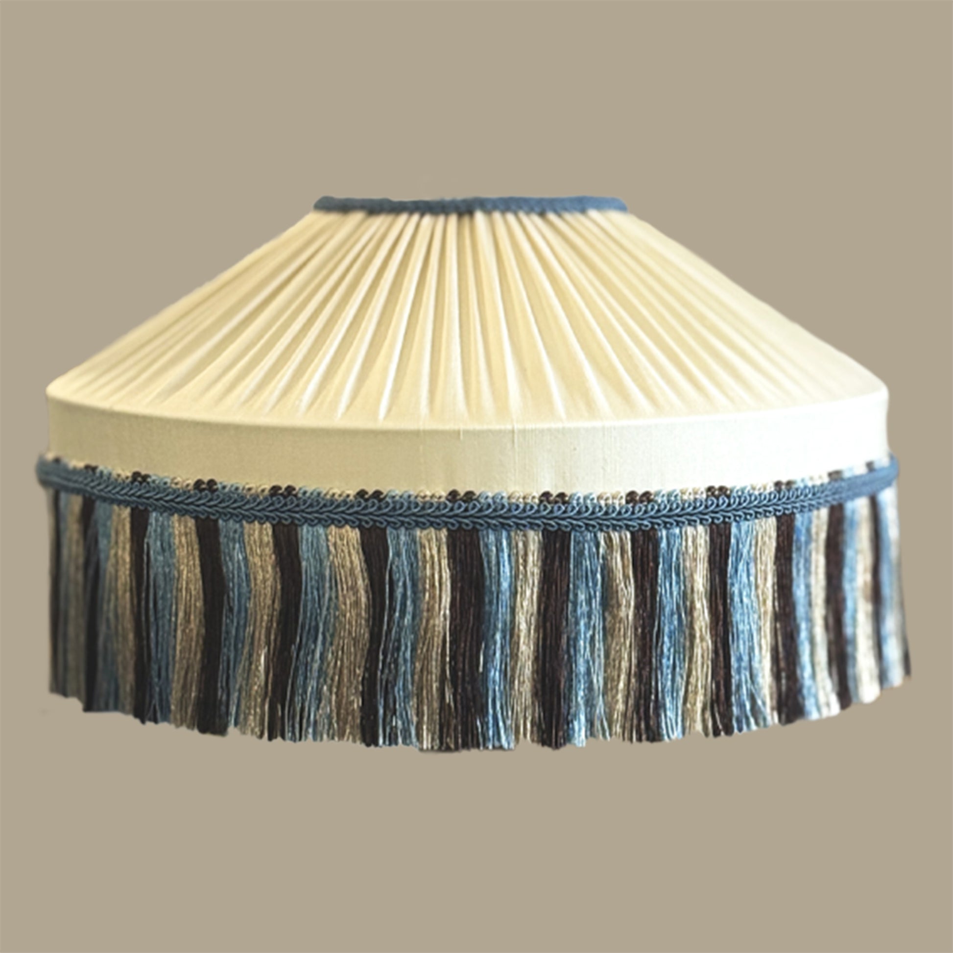 Cream pleated lampshade with blue fringe