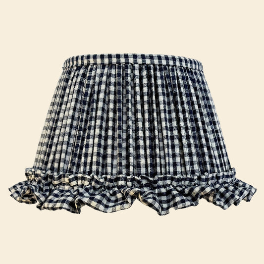 Indigo and white checkered lampshades with ruffled edges on a beige background