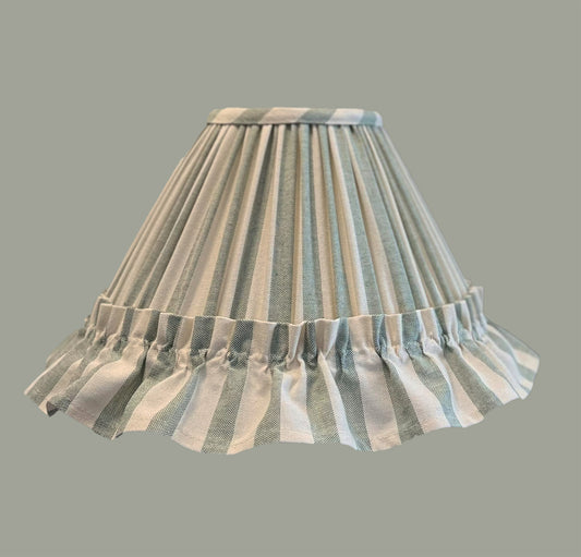 Striped lampshade with ruffled edge on a gray background