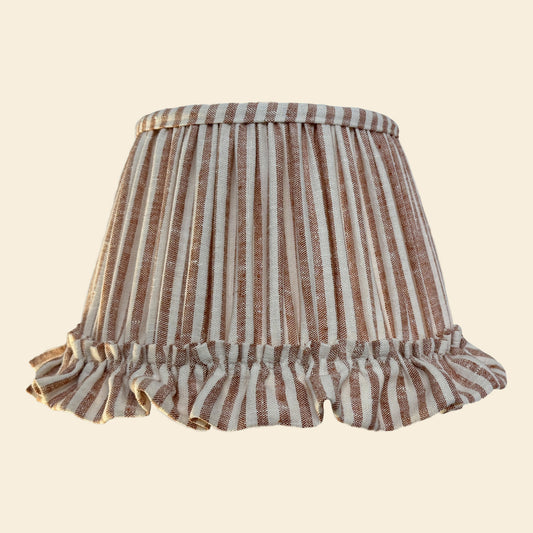 Striped lampshade with ruffled edge on a beige background