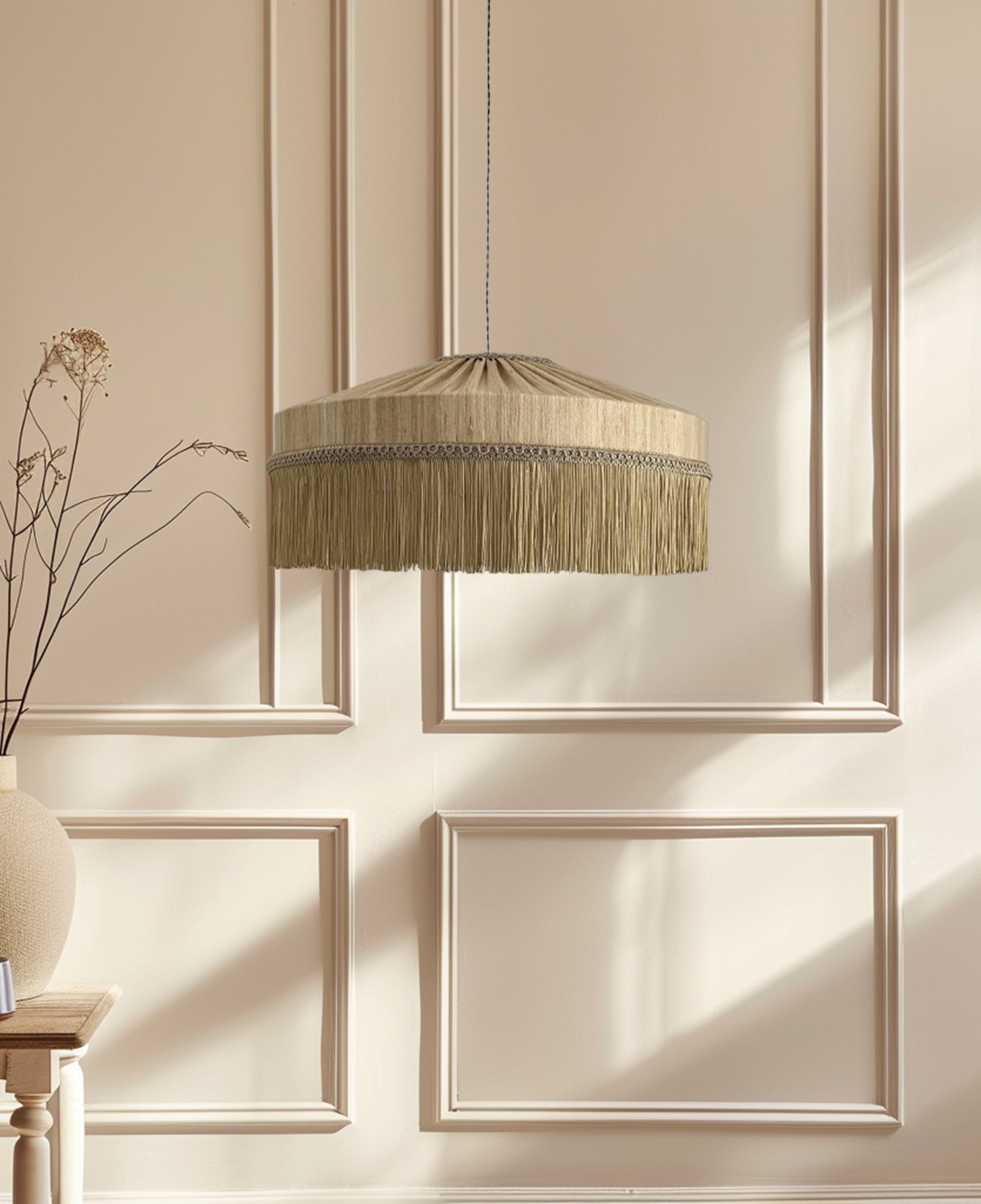 Decorative pendant light with fringe against a wall with paneling