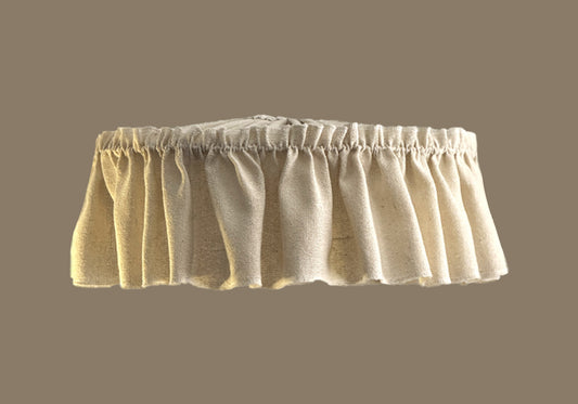 Beige fabric skirt lampshade on a beige background