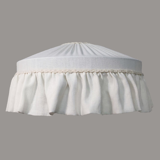 White lampshade with a pleated design on a gray background