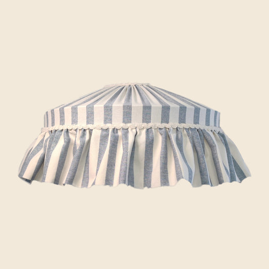 Striped lampshade with blue and white pattern on a beige background
