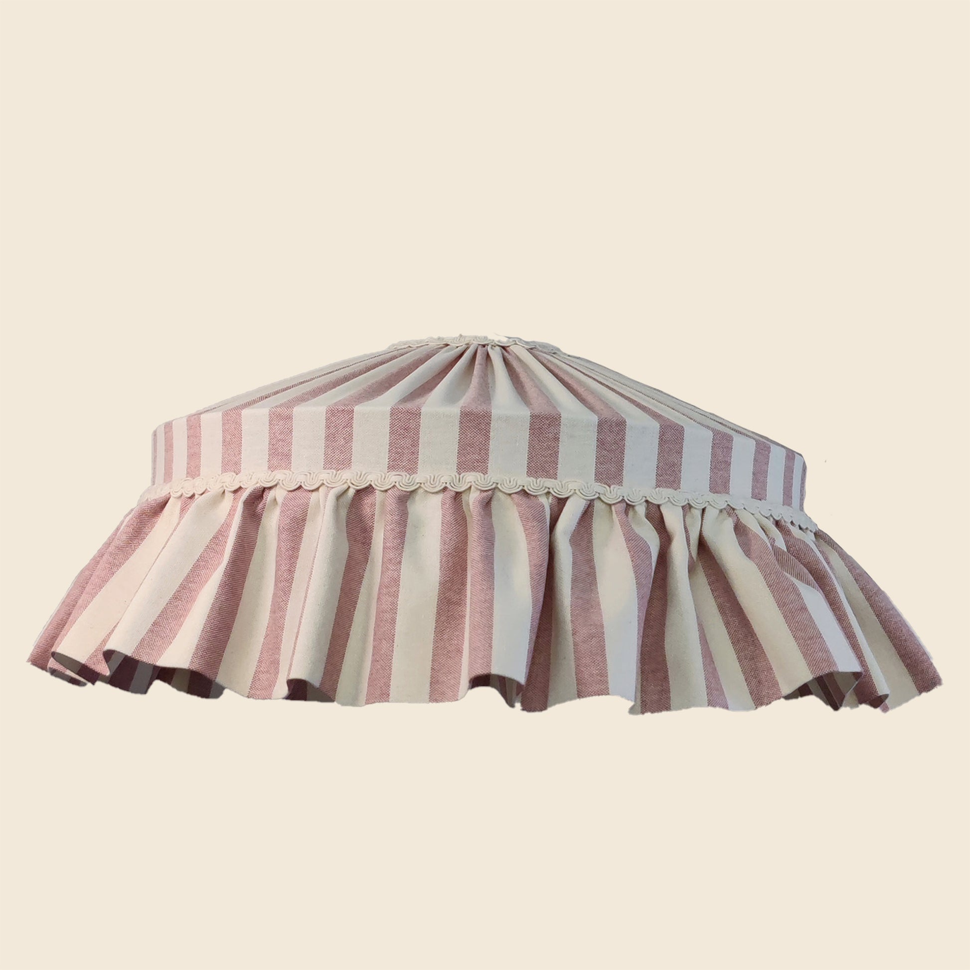 Striped lampshade with ruffled edge on a beige background