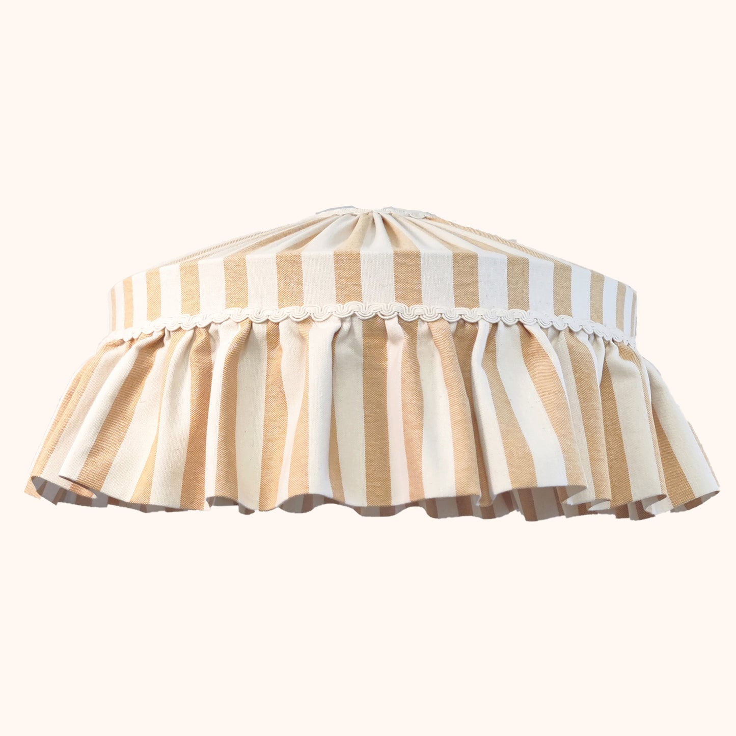 Ruffled lampshade with ochre and white stripes on a white background